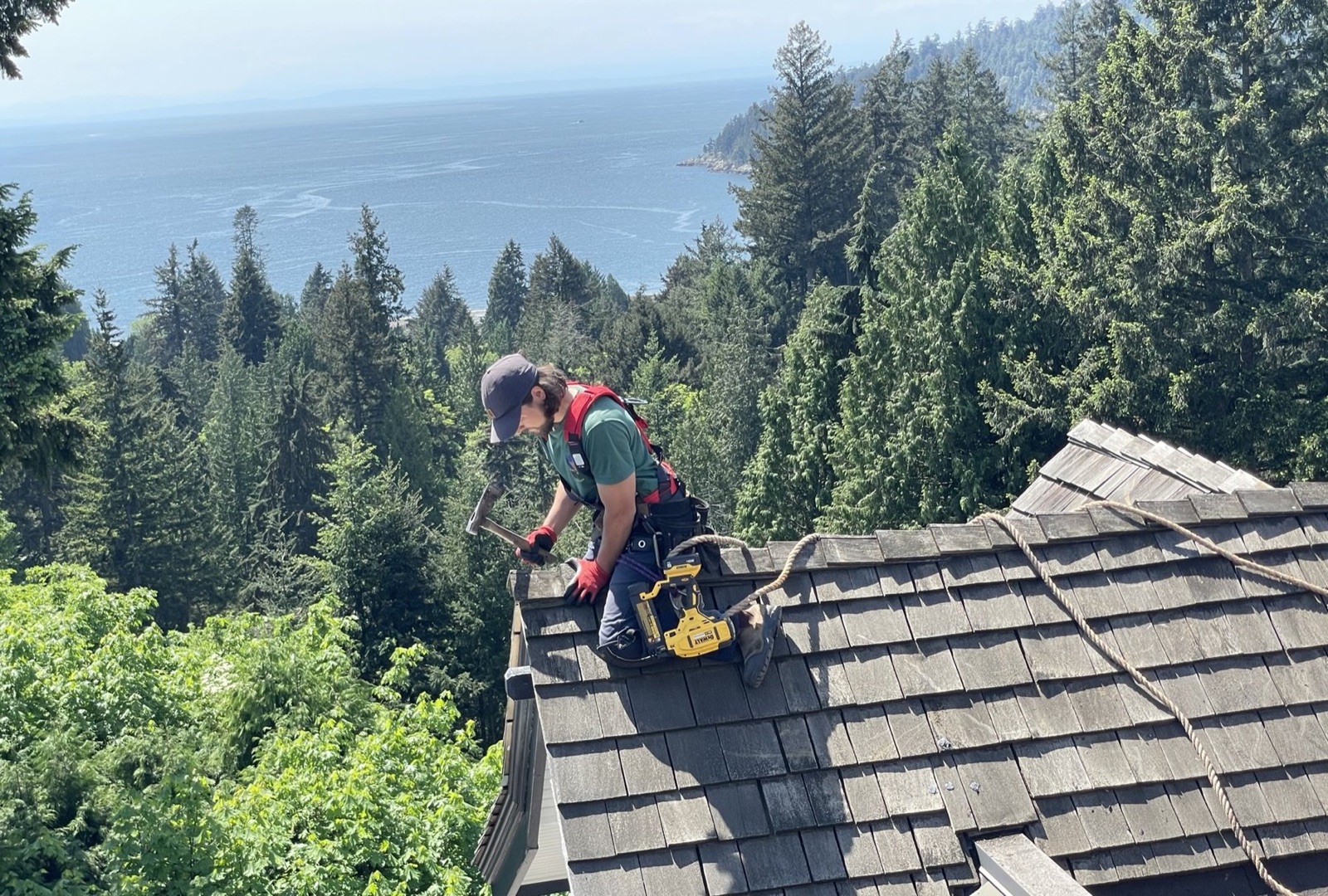 Roofkeeper working on a residential roof above the ocean in West Vancouver